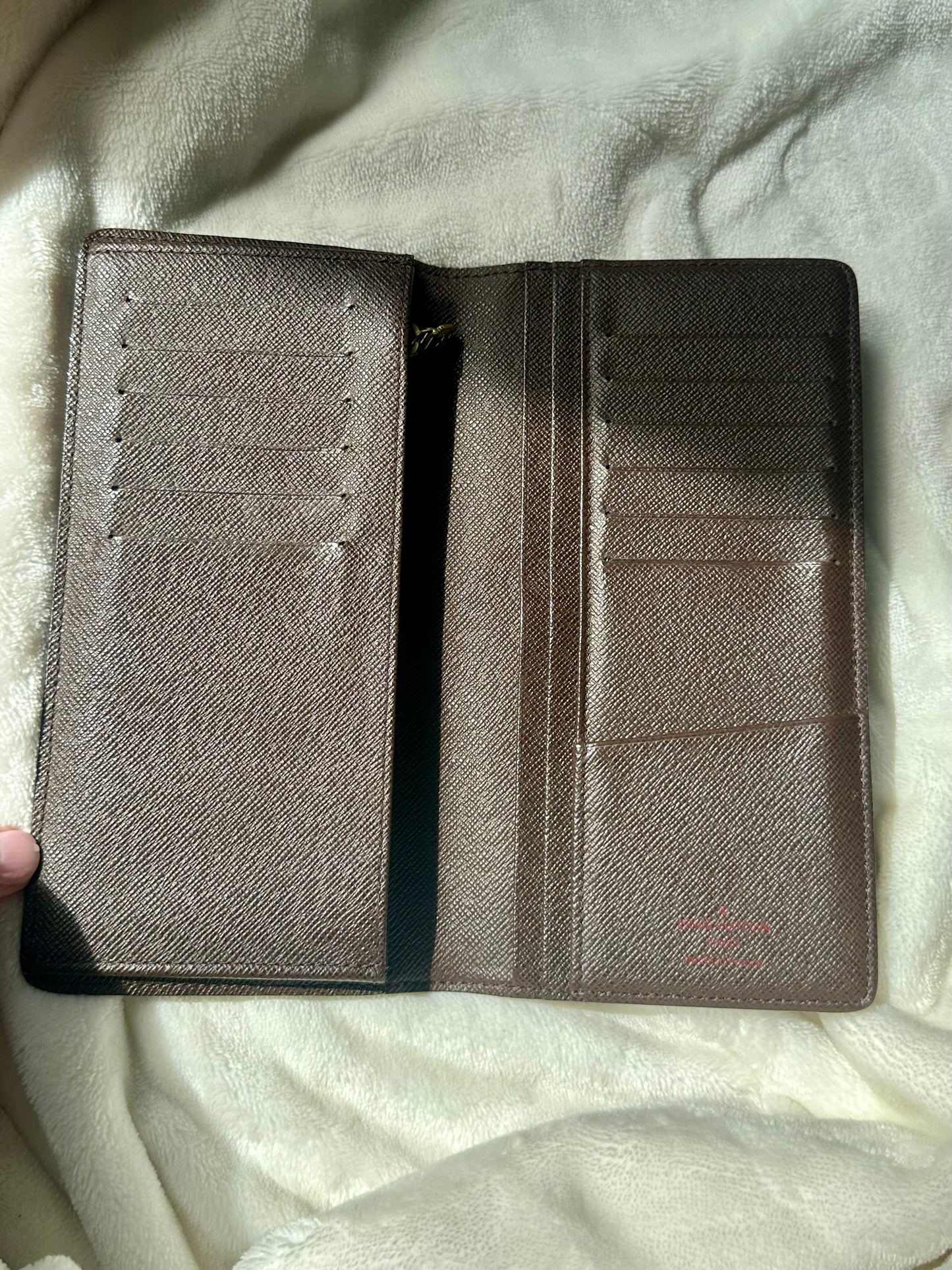 Louis Vuitton vertical bi-fold long wallet in Damier Ebene coated canvas
