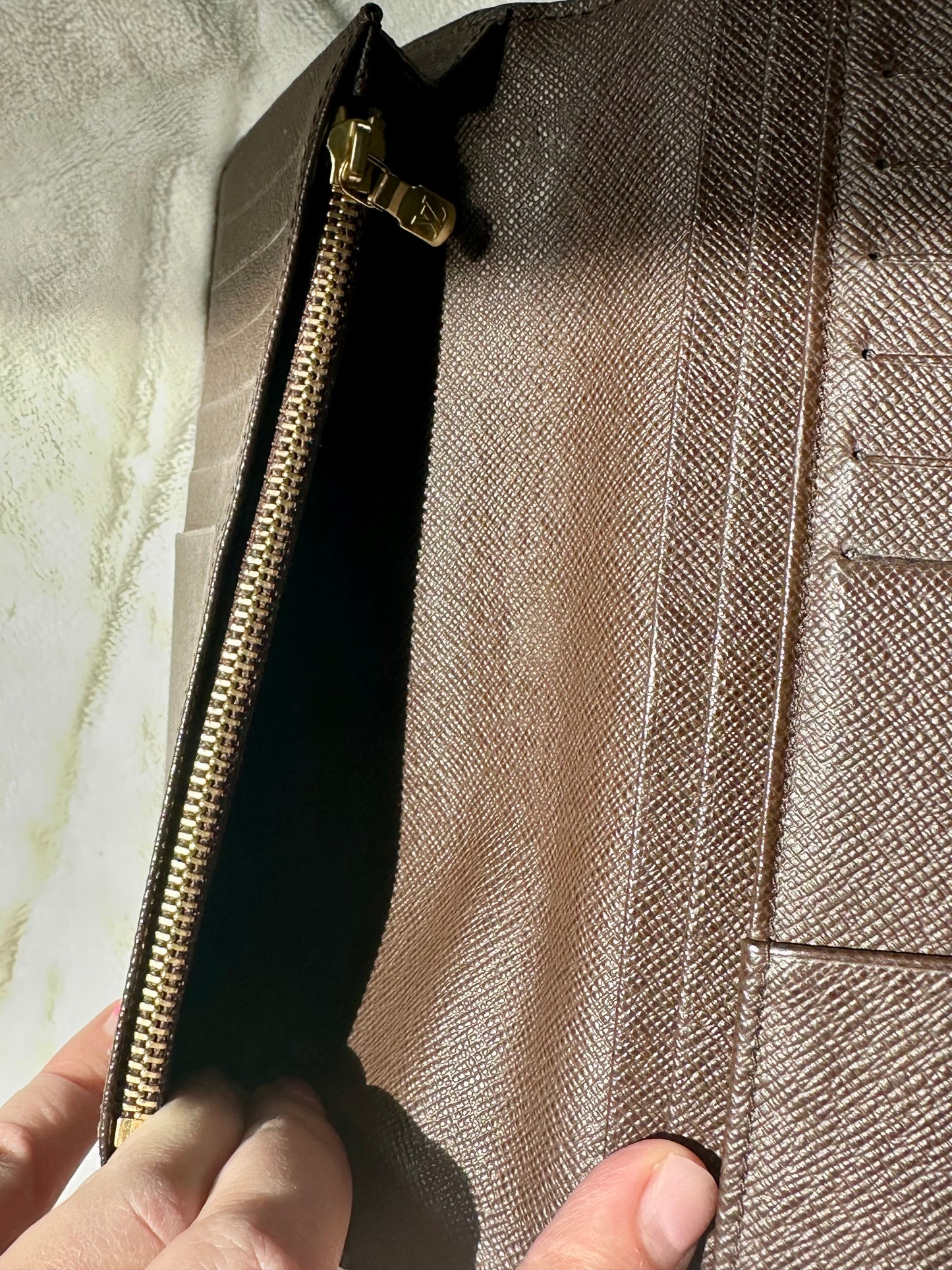 Louis Vuitton vertical bi-fold long wallet in Damier Ebene coated canvas