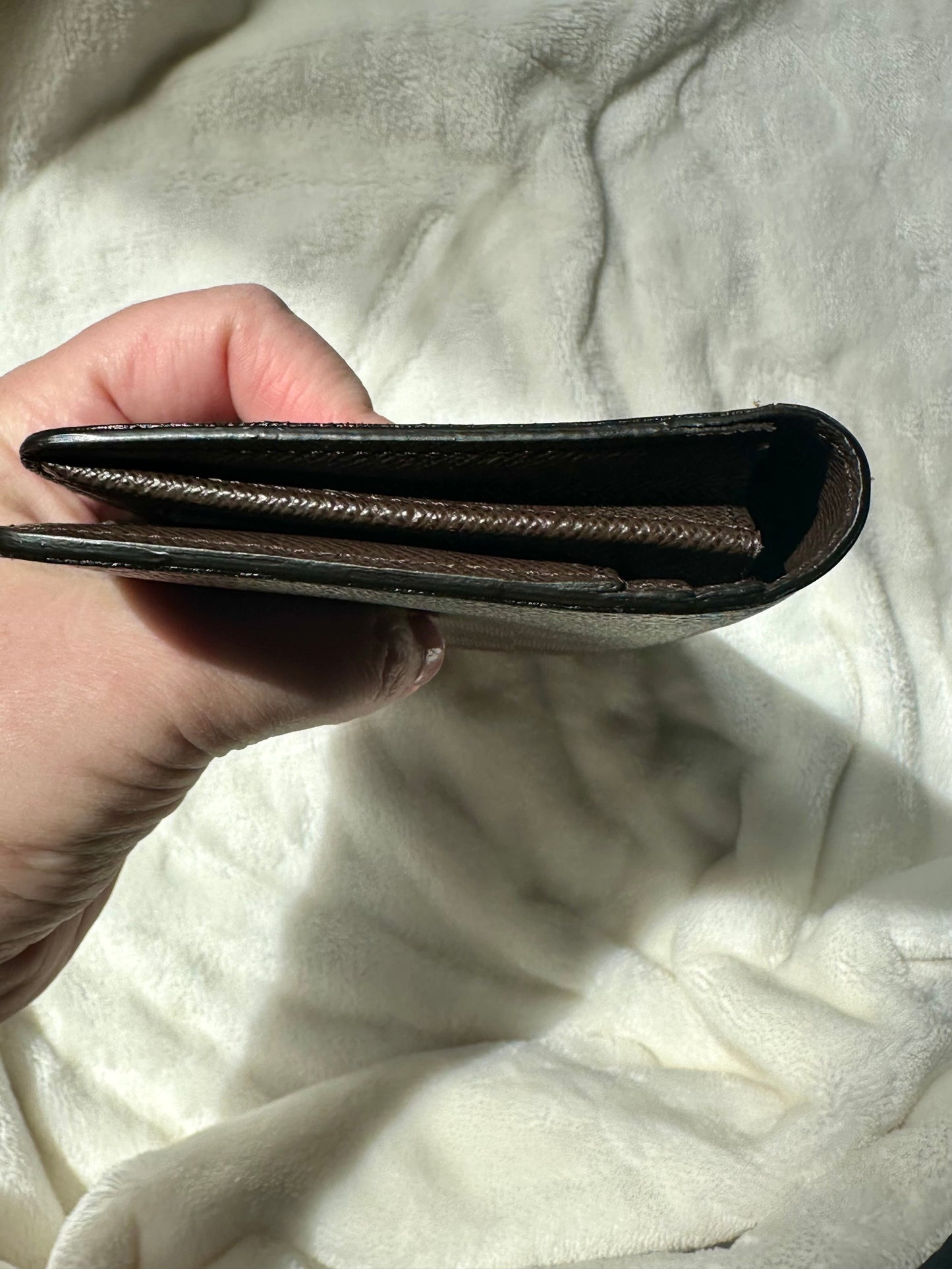 Louis Vuitton vertical bi-fold long wallet in Damier Ebene coated canvas